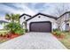 A charming house with a brown garage door and landscaped yard at 4761 San Martino Dr, Wesley Chapel, FL 33543