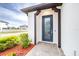 A stylish front door entry with a glass panel and landscaping at 4761 San Martino Dr, Wesley Chapel, FL 33543