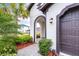 A welcoming front entry with an arched walkway and lush landscaping at 4761 San Martino Dr, Wesley Chapel, FL 33543