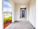 A covered entryway with arched walkways leading to a blue front door at 4761 San Martino Dr, Wesley Chapel, FL 33543