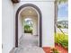 An arched walkway leading to a front door with brick paving at 4761 San Martino Dr, Wesley Chapel, FL 33543