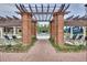 Resort-style pool area with brick pergola and lounge chairs at 4761 San Martino Dr, Wesley Chapel, FL 33543