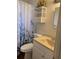 Clean bathroom with white vanity and wicker shelving at 4940 Rosedale Ln, Holiday, FL 34690