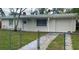 Charming ranch home with a well-maintained lawn and driveway at 4940 Rosedale Ln, Holiday, FL 34690