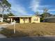 Ranch-style house with a well-maintained lawn and single car garage at 5163 Jasmine Cir, St Petersburg, FL 33714