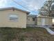 Rear view of the house showcasing a small patio and detached shed at 5163 Jasmine Cir, St Petersburg, FL 33714