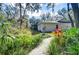 Landscaped backyard path leading to the pool and screened enclosure at 5823 Audubon Manor Blvd, Lithia, FL 33547