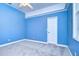 Simple bedroom with light blue walls and carpet at 5823 Audubon Manor Blvd, Lithia, FL 33547