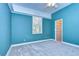 Blue bedroom with a walk-in closet and window at 5823 Audubon Manor Blvd, Lithia, FL 33547