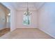 Formal dining room with chandelier and neutral carpeting at 5823 Audubon Manor Blvd, Lithia, FL 33547