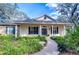 Charming one-story home with brick facade, covered porch, and landscaped yard at 5823 Audubon Manor Blvd, Lithia, FL 33547