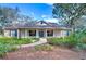 One-story house with front porch, brick accents, and lush landscaping at 5823 Audubon Manor Blvd, Lithia, FL 33547