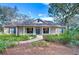 Charming single-story home with lush landscaping and inviting front porch at 5823 Audubon Manor Blvd, Lithia, FL 33547