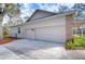 Two-car garage with brick accents and ample driveway space at 5823 Audubon Manor Blvd, Lithia, FL 33547