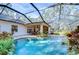 Inviting pool area with a covered patio and lush tropical landscaping at 5823 Audubon Manor Blvd, Lithia, FL 33547