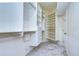 Bright walk-in closet with built-in shelves and rods at 5823 Audubon Manor Blvd, Lithia, FL 33547