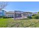 Home exterior showcasing backyard and screened patio at 6321 Voyagers Pl, Apollo Beach, FL 33572