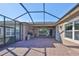 Spacious covered patio with stone wall and screened enclosure at 6321 Voyagers Pl, Apollo Beach, FL 33572