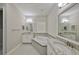 Modern bathroom with a double vanity and a corner soaking tub at 6321 Voyagers Pl, Apollo Beach, FL 33572