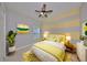 Charming bedroom with yellow and gray decor, a large bed and a window at 6321 Voyagers Pl, Apollo Beach, FL 33572