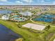 Aerial view of community amenities including pools, tennis courts, and a clubhouse at 6321 Voyagers Pl, Apollo Beach, FL 33572