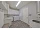 Bright laundry room with washer, dryer, and ample cabinetry at 6321 Voyagers Pl, Apollo Beach, FL 33572