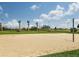 Outdoor sand volleyball court with a net and surrounding grassy area at 6321 Voyagers Pl, Apollo Beach, FL 33572