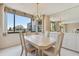 Bright dining room with table, chairs, and view of the water at 644 Island Way # 206, Clearwater, FL 33767