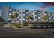 Condo building's exterior and parking area at sunset at 644 Island Way # 206, Clearwater, FL 33767