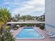 Community pool with ample lounge chairs and picnic tables at 644 Island Way # 206, Clearwater, FL 33767