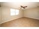 Well-lit bedroom with tile flooring and a ceiling fan at 6911 El Camino Paloma St, Port Richey, FL 34668