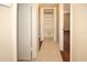 Long hallway with linen closet and built-in shelving at 6911 El Camino Paloma St, Port Richey, FL 34668