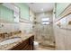 Updated bathroom with granite countertop and walk-in shower at 7007 Lambright Ct, Tampa, FL 33634