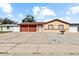 House exterior with a two-car garage and a courtyard at 7007 Lambright Ct, Tampa, FL 33634