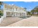 Elegant two-story home featuring a brick paver patio, spiral staircase, pool, and a manicured lawn at 7401 Watersilk Dr, Pinellas Park, FL 33782