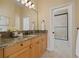 Bathroom with granite countertops, wood cabinets, and a shower visible through the doorway at 7401 Watersilk Dr, Pinellas Park, FL 33782