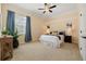 Comfortable bedroom with a ceiling fan and a large window with curtains at 7401 Watersilk Dr, Pinellas Park, FL 33782