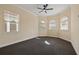 Bedroom featuring neutral colored walls, dark carpet, with three windows and white blinds at 7401 Watersilk Dr, Pinellas Park, FL 33782