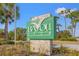 Bayou Club community sign with lush greenery at 7401 Watersilk Dr, Pinellas Park, FL 33782