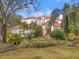 Stunning white home with a terracotta roof, lush landscaping and mature trees at 7401 Watersilk Dr, Pinellas Park, FL 33782