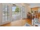 Living room with french doors opening to the pool area and kitchen at 7401 Watersilk Dr, Pinellas Park, FL 33782