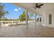 Covered patio with brick pavers, columns and white fencing overlooking the pool and golf course at 7401 Watersilk Dr, Pinellas Park, FL 33782