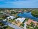 Aerial view of the home and the community with a lake and golf course at 7566 Links Ct, Sarasota, FL 34243