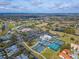 Aerial view of the golf course, tennis courts, swimming pool, and clubhouse at 7566 Links Ct, Sarasota, FL 34243