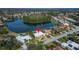 Aerial view of the home and the community with a lake at 7566 Links Ct, Sarasota, FL 34243