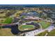 An aerial view of the clubhouse with a swimming pool and golf course at 7566 Links Ct, Sarasota, FL 34243