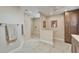 Bathroom featuring step in shower, separate toilet, and long vanity with ample storage space at 7566 Links Ct, Sarasota, FL 34243