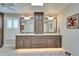 Bathroom featuring double sinks and vanities, a skylight, and neutral paint palette at 7566 Links Ct, Sarasota, FL 34243