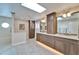 Bathroom featuring double sink vanity, step-in shower, soaking tub, and decorative lighting at 7566 Links Ct, Sarasota, FL 34243