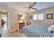 Comfortable bedroom featuring neutral walls, a ceiling fan, tiled floors, and natural light at 7566 Links Ct, Sarasota, FL 34243